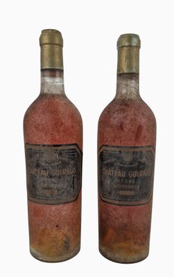 two bottles of wine are sitting next to each other on a white surface