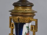 a blue and white vase with gold decoration on it