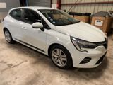 the white car is parked in the garage in front of boxes
