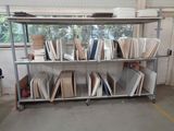 a metal rack with many books on it in a room