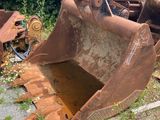 an old bulldozer sitting in the middle of a field
