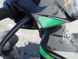 a close up of a motorcycle with a green and black handlebar