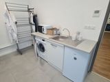 a kitchen with a washer and a dryer in it