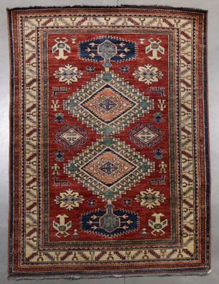 a red and blue rug with a diamond design on it