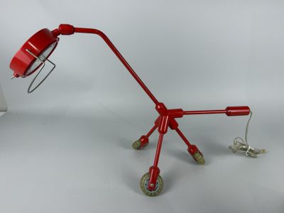 a red lamp that is sitting on top of a table