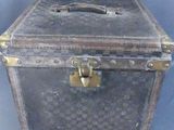 an old suitcase that is sitting on a blue surface