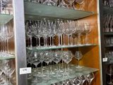 many wine glasses on the shelves in the room