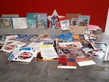 a lot of books on the floor next to a red wall
