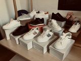 many pairs of shoes that are on a table