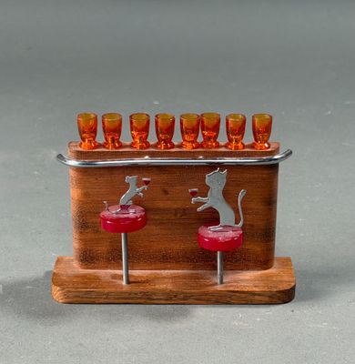 a wooden stand with glasses and a cat on it