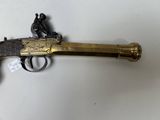 an old gun is on a table with a tag attached to it