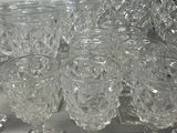 a lot of glasses that are sitting on a table