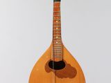 an image of a mandolin hanging from a string on a wall
