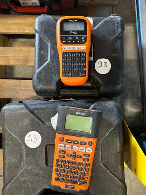 two orange and black cell phones sitting on top of a black case