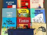 a lot of books that are sitting on the floor