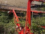 a red machine that is sitting in the grass