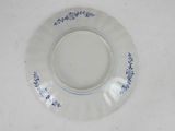 a white plate with blue flowers on it on a table