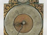 a clock that is sitting on a white surface