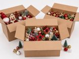 three boxes filled with christmas ornaments sit on a white surface
