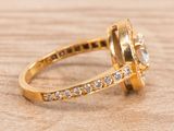 an image of a close up of a diamond ring on a wooden surface