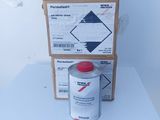 a can of paint next to a cardboard box on a table