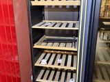 a wine cooler that is open and empty in the store