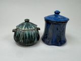 two small blue and green pots sitting next to each other