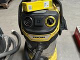 a vacuum that is sitting on the floor in the room