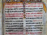 un vieux livre sur lequel figurent des inscriptions et une croix au milieu