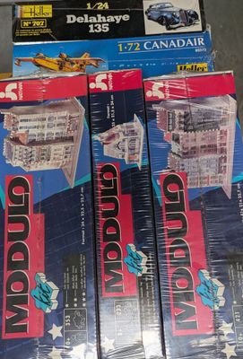 three boxes of legos are stacked on top of each other on a table