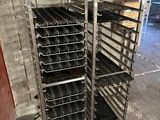 many trays of food on a rack in the kitchen