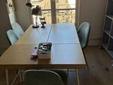 a table with a book on it in front of a window