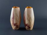 two vases that are sitting next to each other on a table