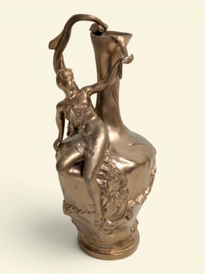 a bronze statue of a woman sitting on a vase