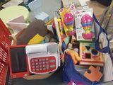 a basket full of toys and a cell phone on a table