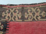an image of a red and black rug with a pattern on it