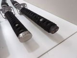 two black and silver handles on a white counter
