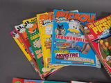 several children ' s magazines are stacked on top of each other on a table