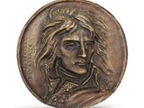 a close up of a coin with a man ' s face on it