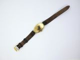 an image of a watch on a white surface with a brown strap