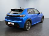 the rear end of a blue car in a showroom
