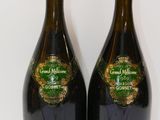 two bottles of wine sitting next to each other on a table