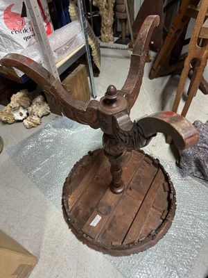 a wooden table with a metal stand on top of it