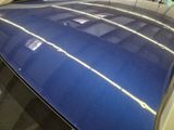 an image of a shiny blue car in a showroom