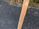 a wooden bench sitting on the side of the road
