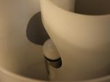 a close up of a white bowl with a light in it