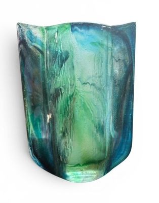 a glass vase with a green and blue design on it