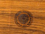 a close up of a wooden table with a logo on it