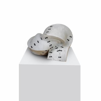 a white box with a pair of shoes on top of it