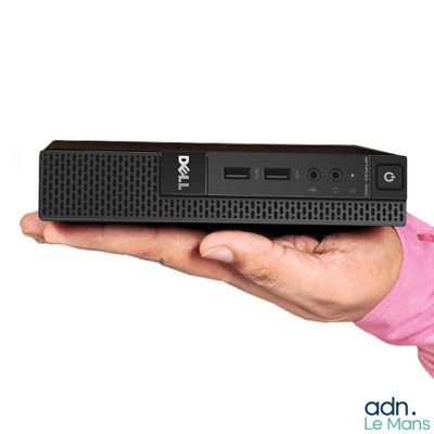 a person holding a small black computer in their hand